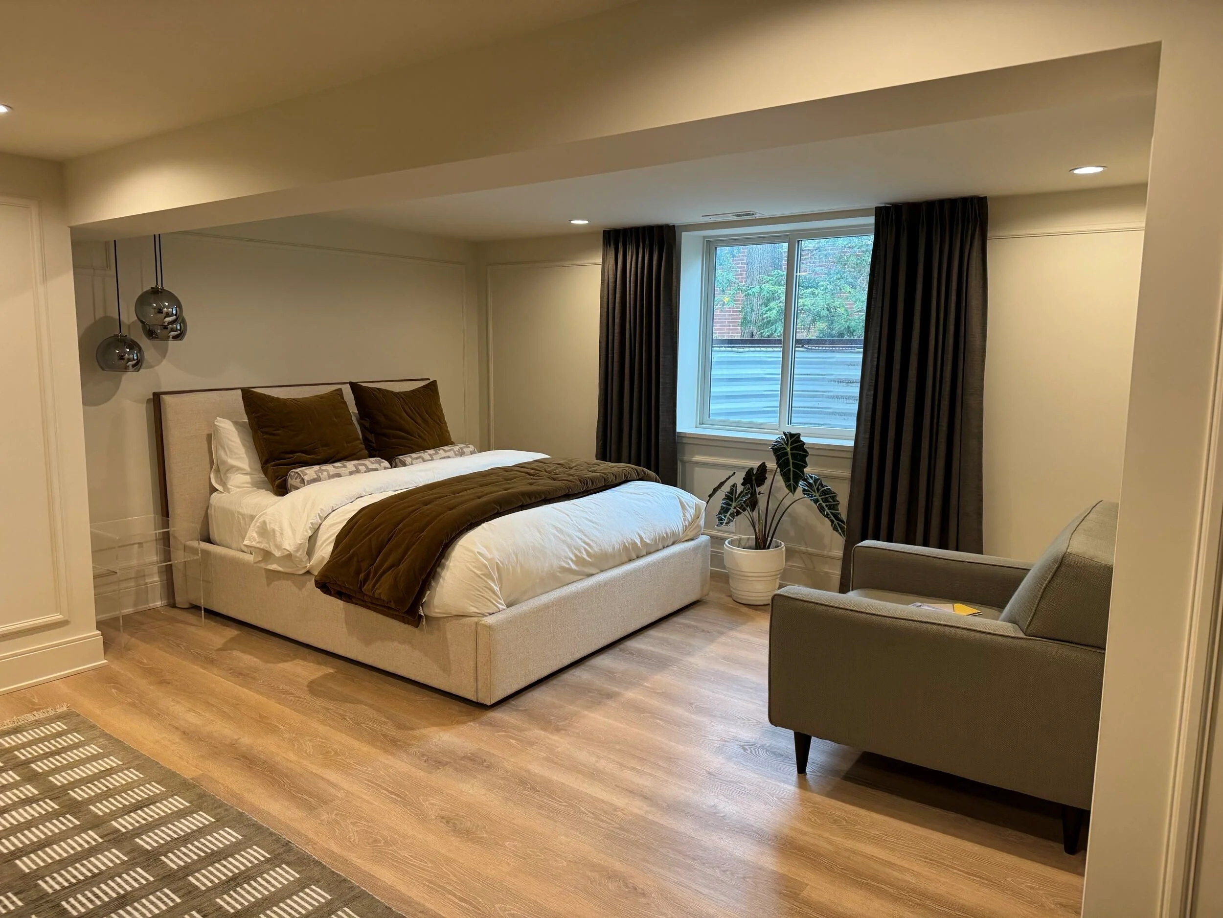 Finished basement bedroom with hardwood floors, built-in bed, glass shower, and recessed lighting
