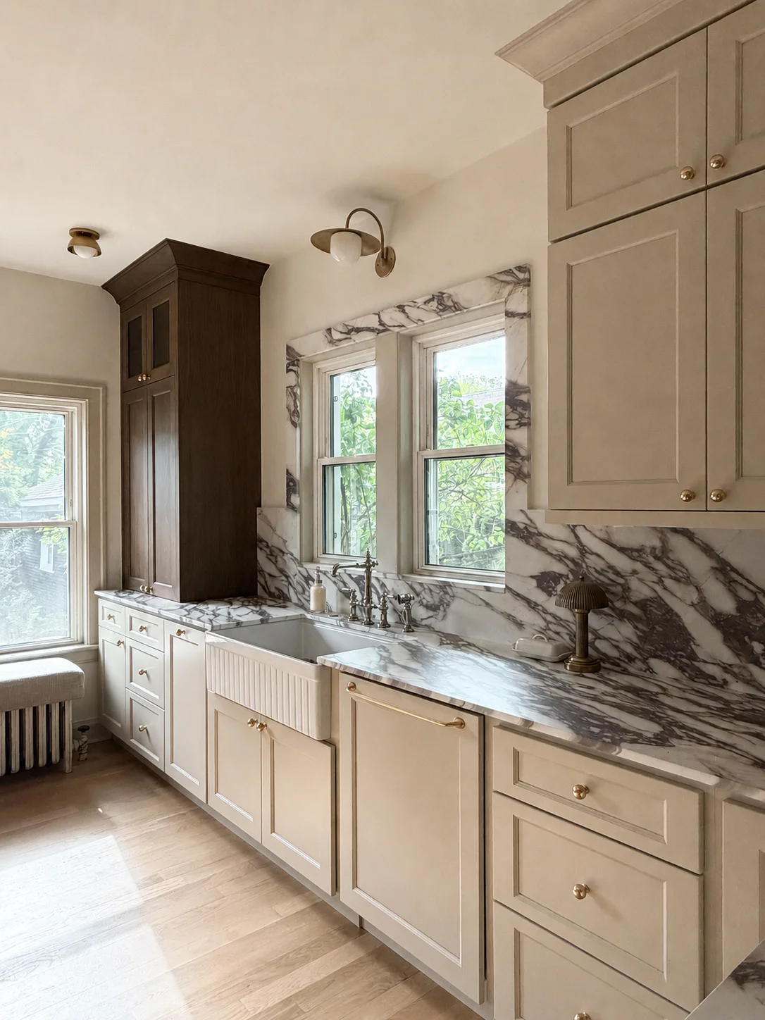 Modern kitchen with cream cabinets, marble backsplash, and dark wood accent cabinetry
