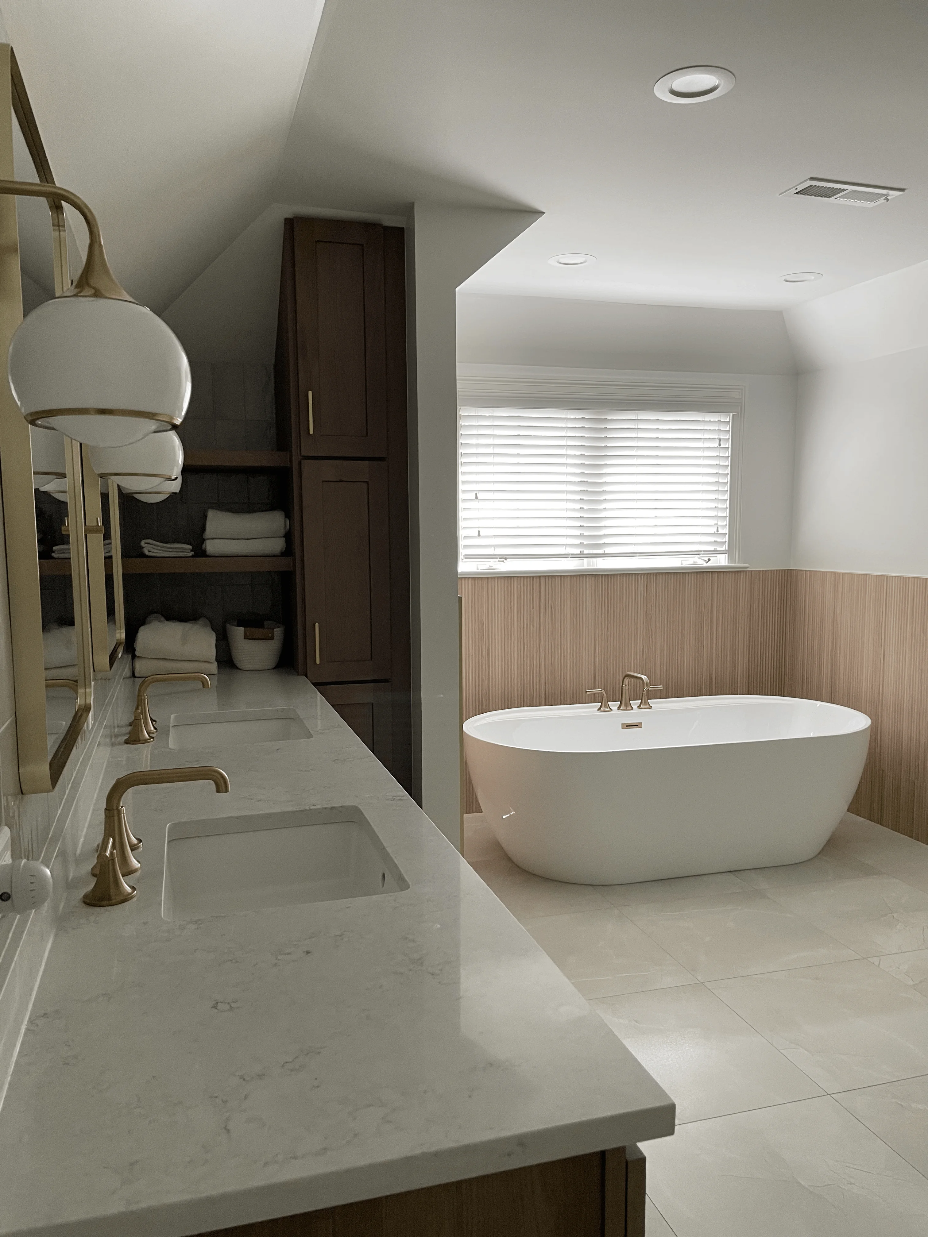 Remodeled bathroom interior in a Westmont, Illinois home featuring a walk-in shower with tile surround, updated vanity, and new flooring. The finished space reflects a full design-build renovation typical of mid-century homes in the Westmont area.